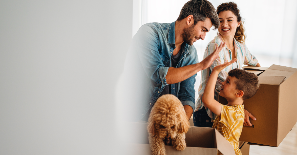 Family and dog with moving boxes
