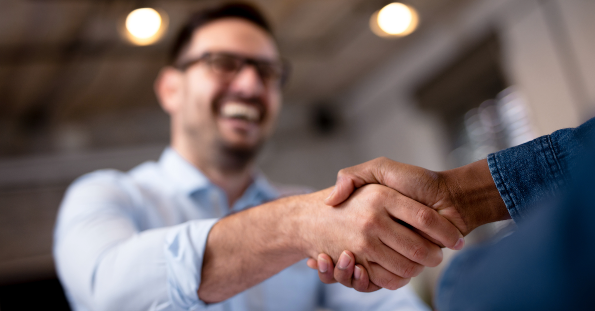 man shaking another person's hand