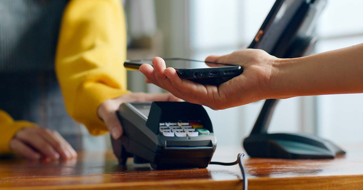 person using mobile wallet at store