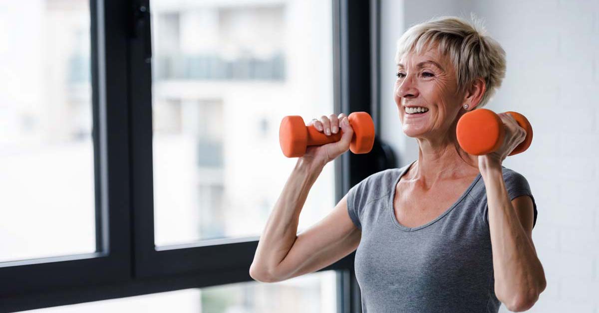 Woman happily lifting weights 