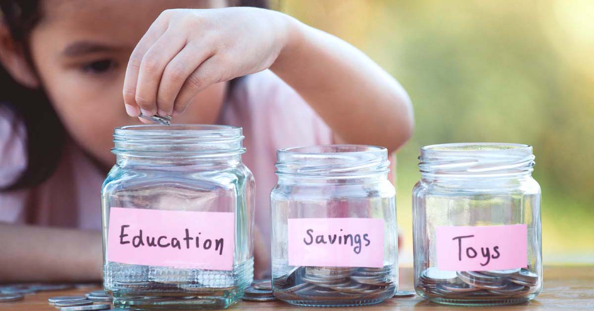 Girl putting coins in jars