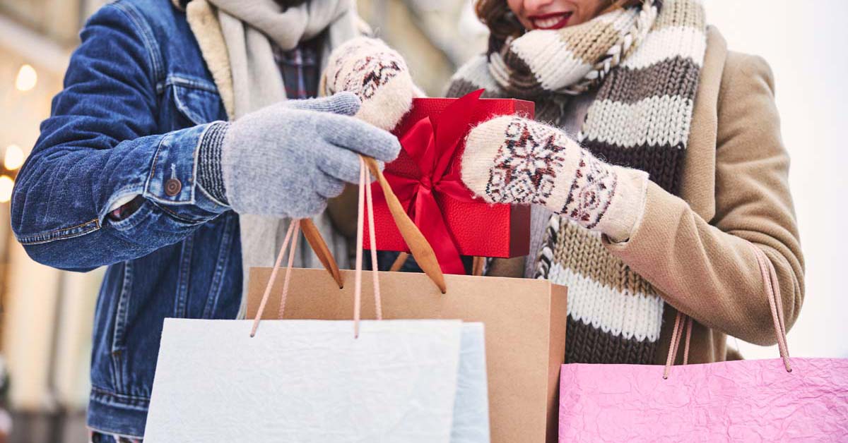 Couple holiday shopping and holding many shopping bags 