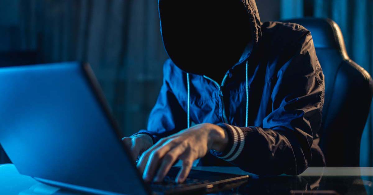 Cyber criminal typing on a computer 